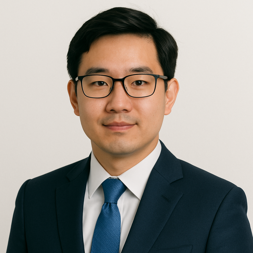 A professional man in a suit and glasses with a neutral background, suitable for business profile or portrait.